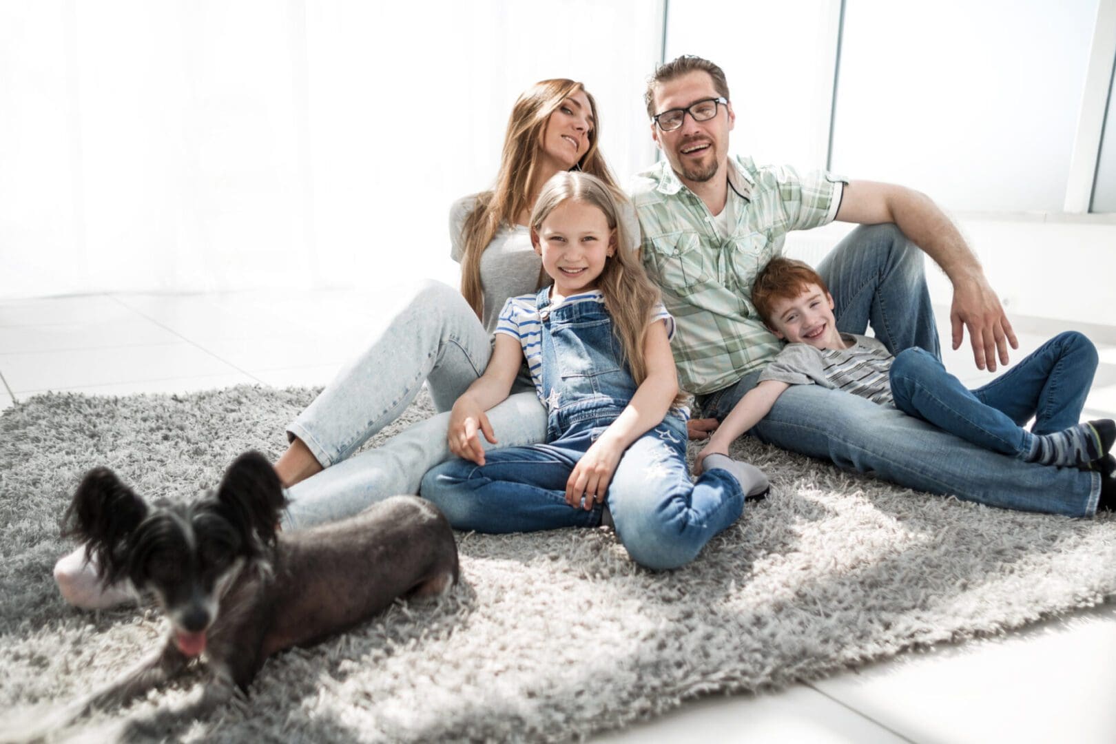 happy family with pet sitting on the carpet.photo with copy space