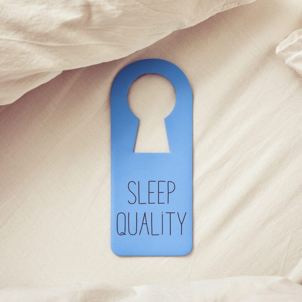 Closeup of a blue door hanger with the text sleep quality written in it