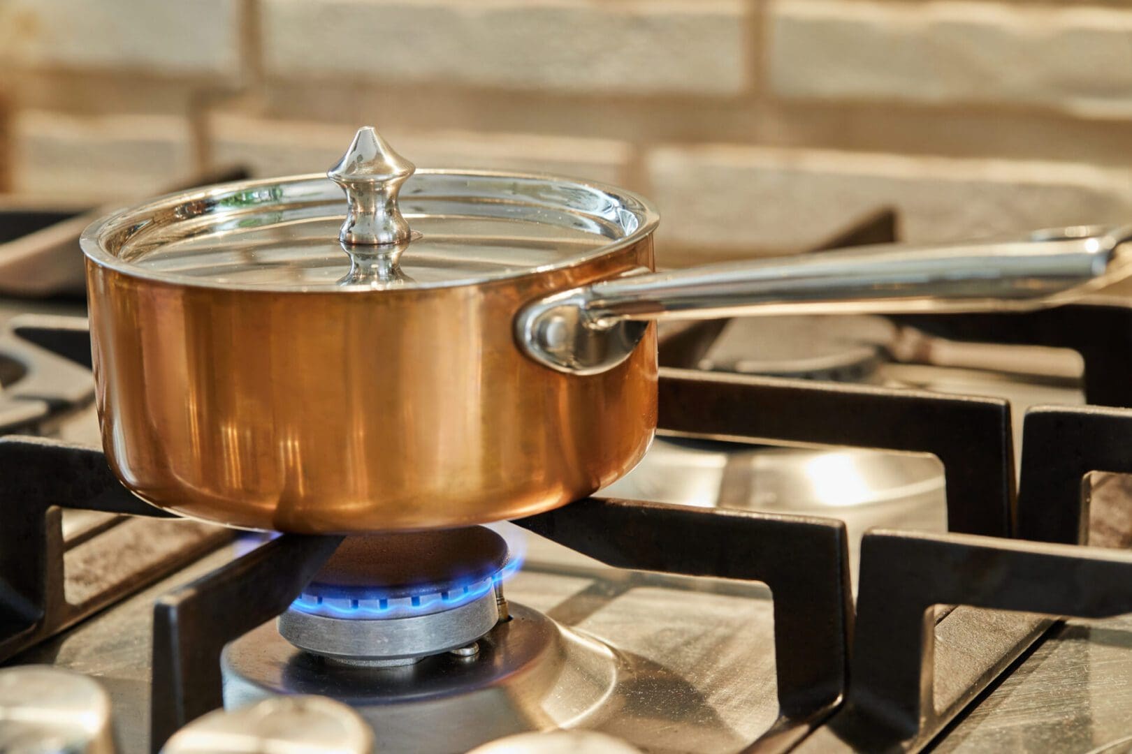 Copper saucepan over low heat on stove to make sauce.